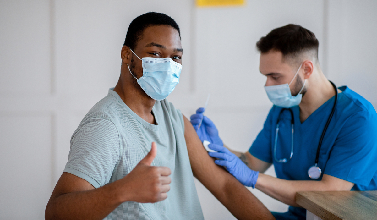 Man giving thumbs up, vaccination